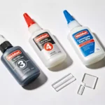 Weldon acrylic adhesives and cyanoacrylate glue bottles with bonded acrylic samples