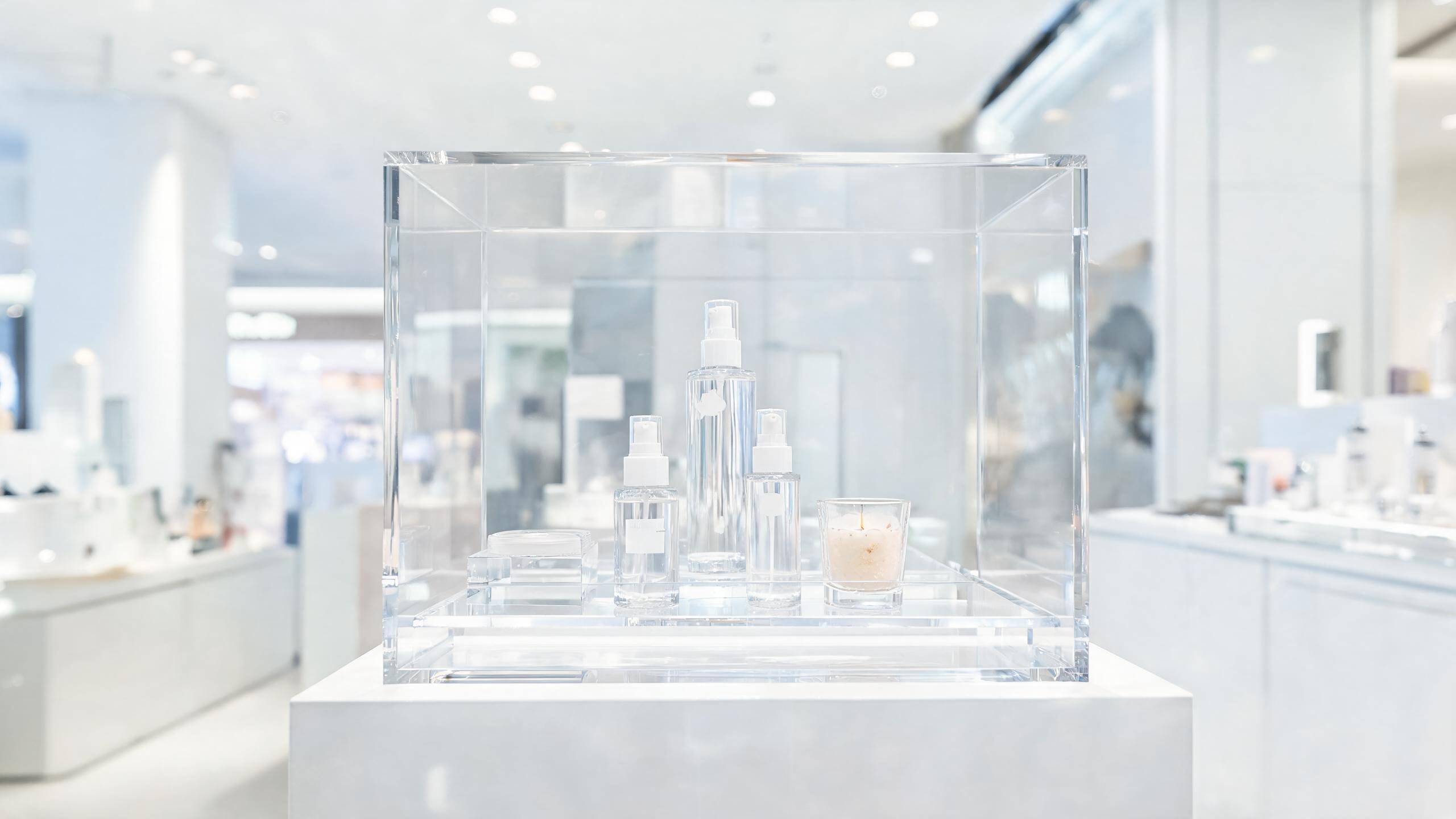 Clear acrylic display case showcasing products in retail store